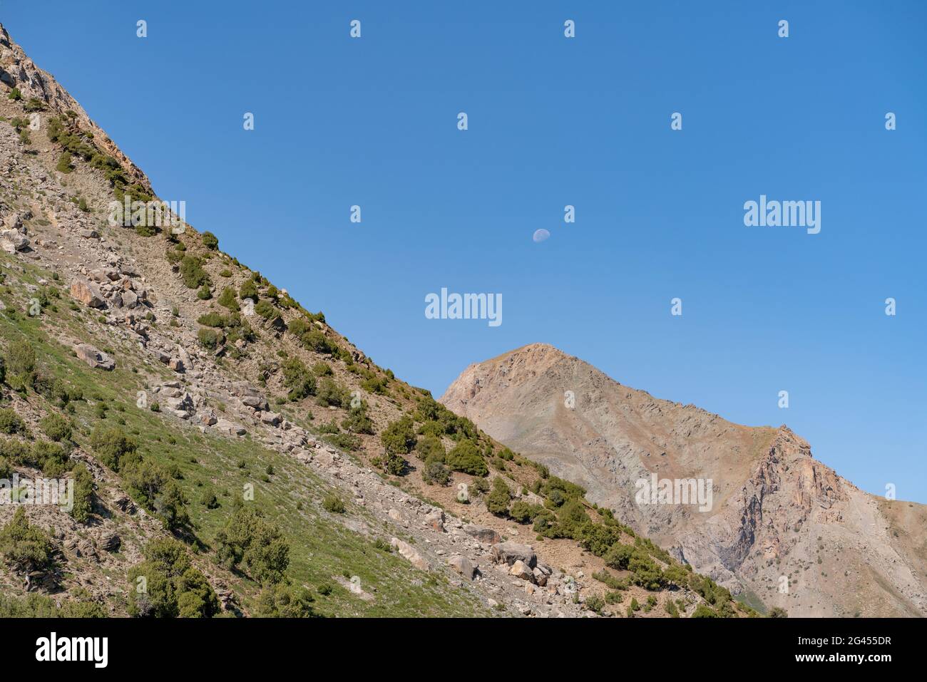 The beautiful mountain trekking road with clear blue sky and rocky hills in Fann mountains in Tajikistan Stock Photo
