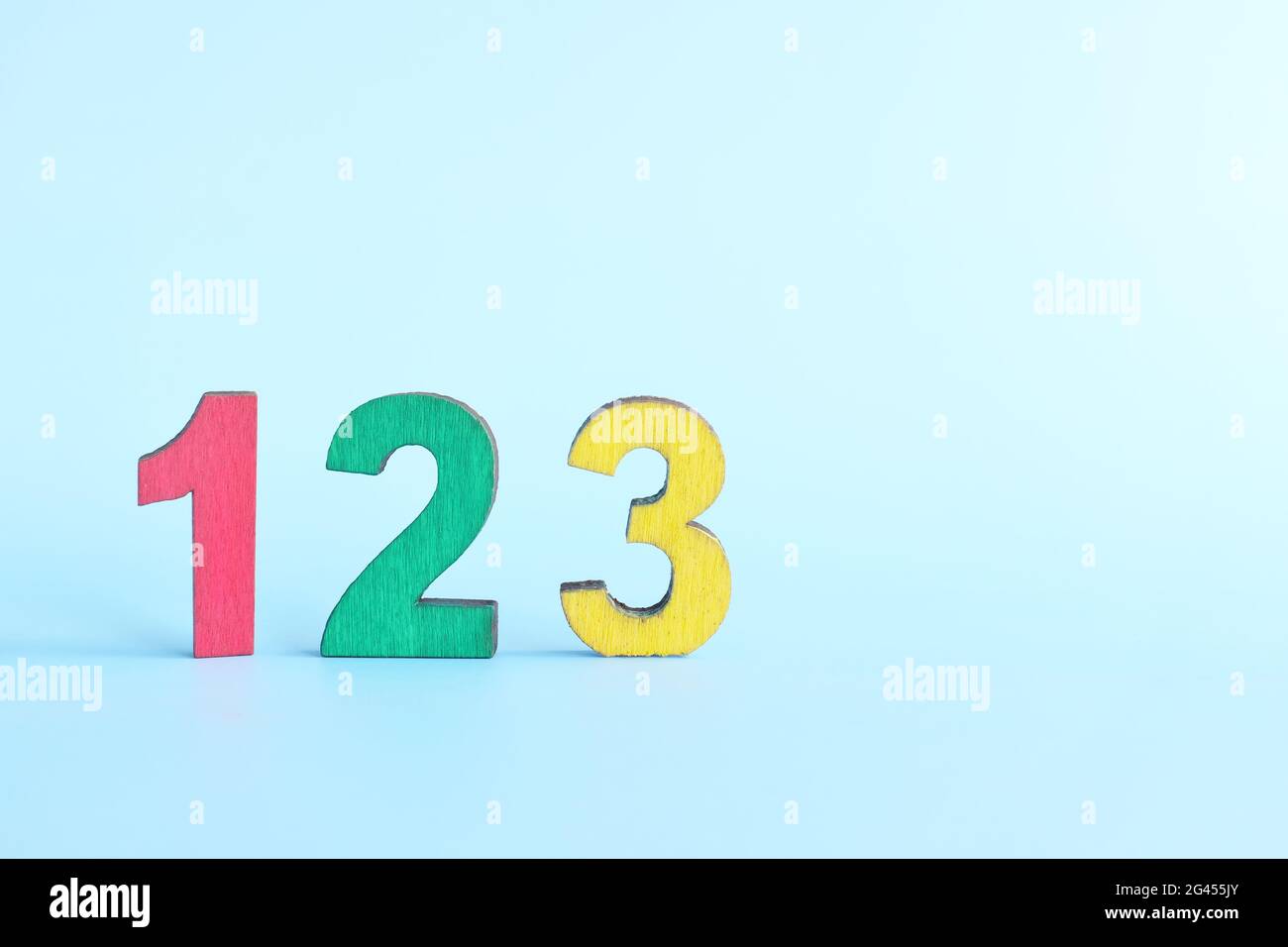 Colorful 123 numbers on wooden blocks in blue background with copy ...