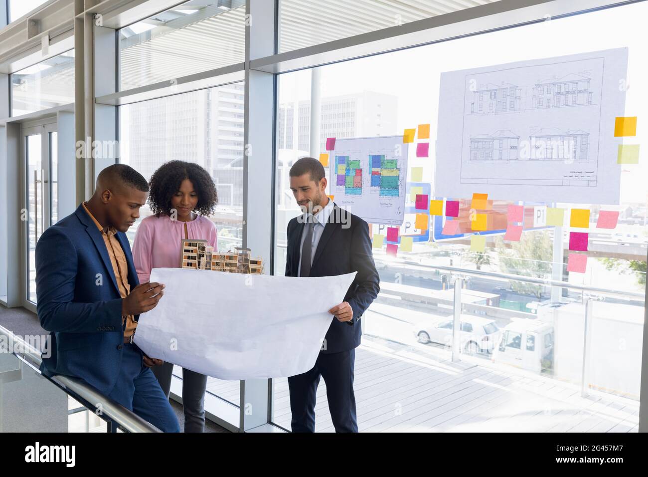 Three young architects working together Stock Photo