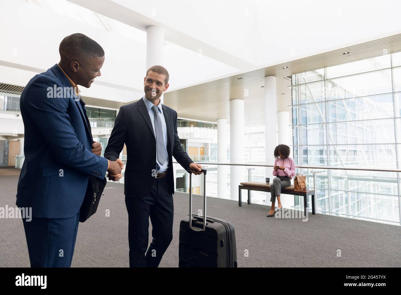 Travelling businessmen shaking hands Stock Photo