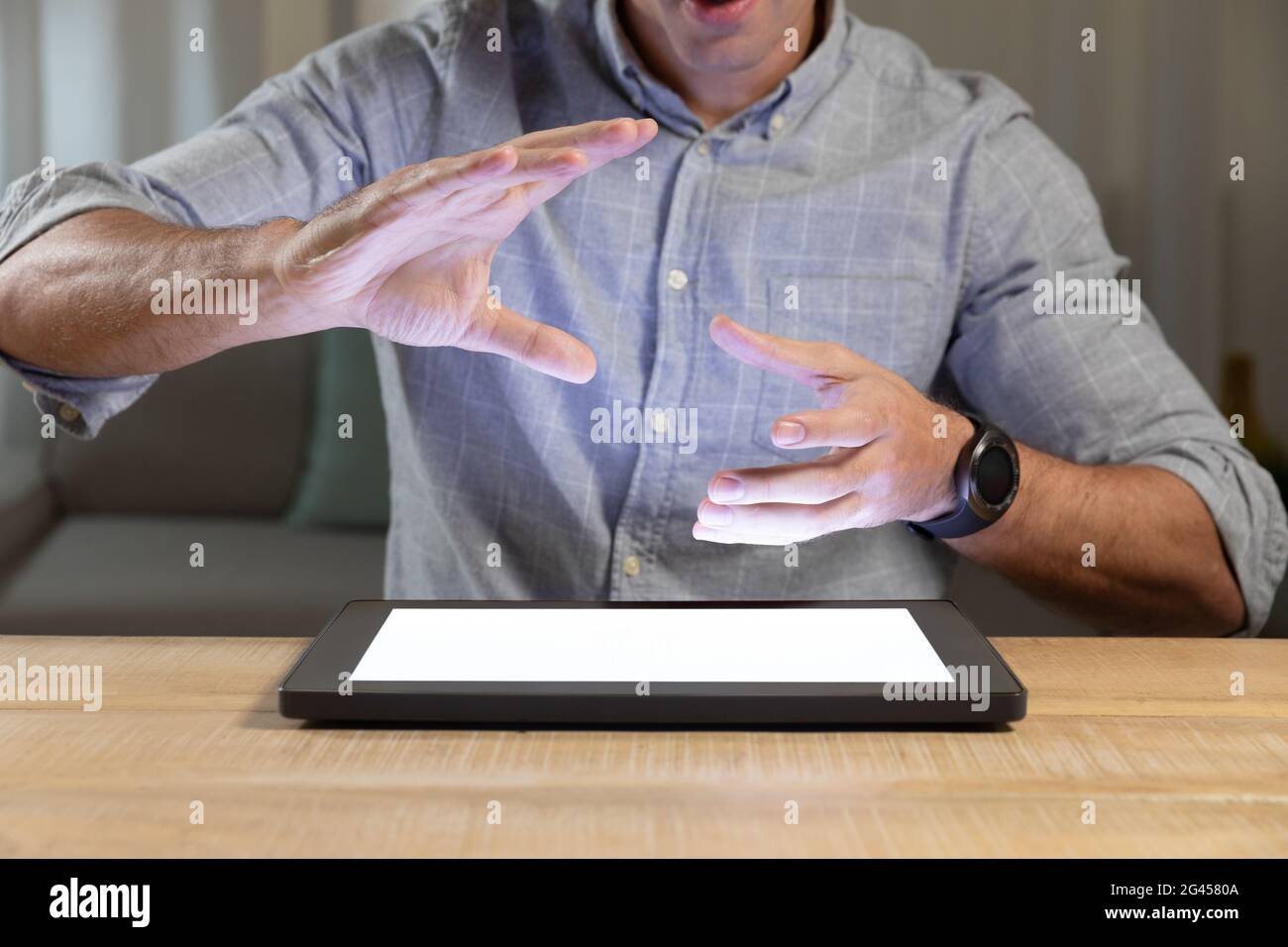 Young man using tablet computer on a table Stock Photo