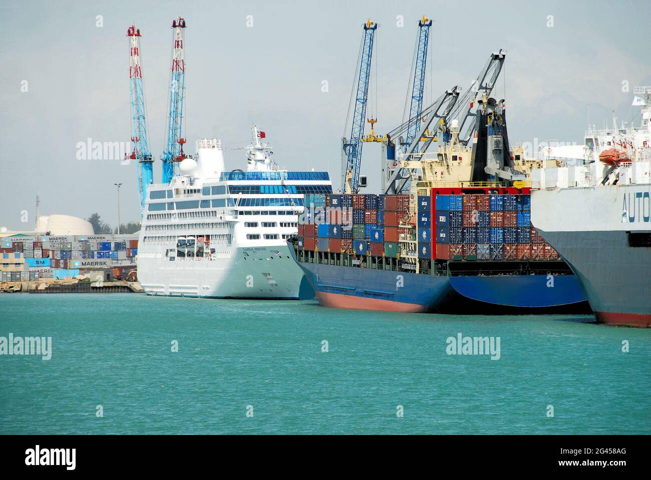 Ships docked at the tropical turquoise waters of  the Autonomous Port of Cotonou, Benin, West Africa on a sunny day. Stock Photo