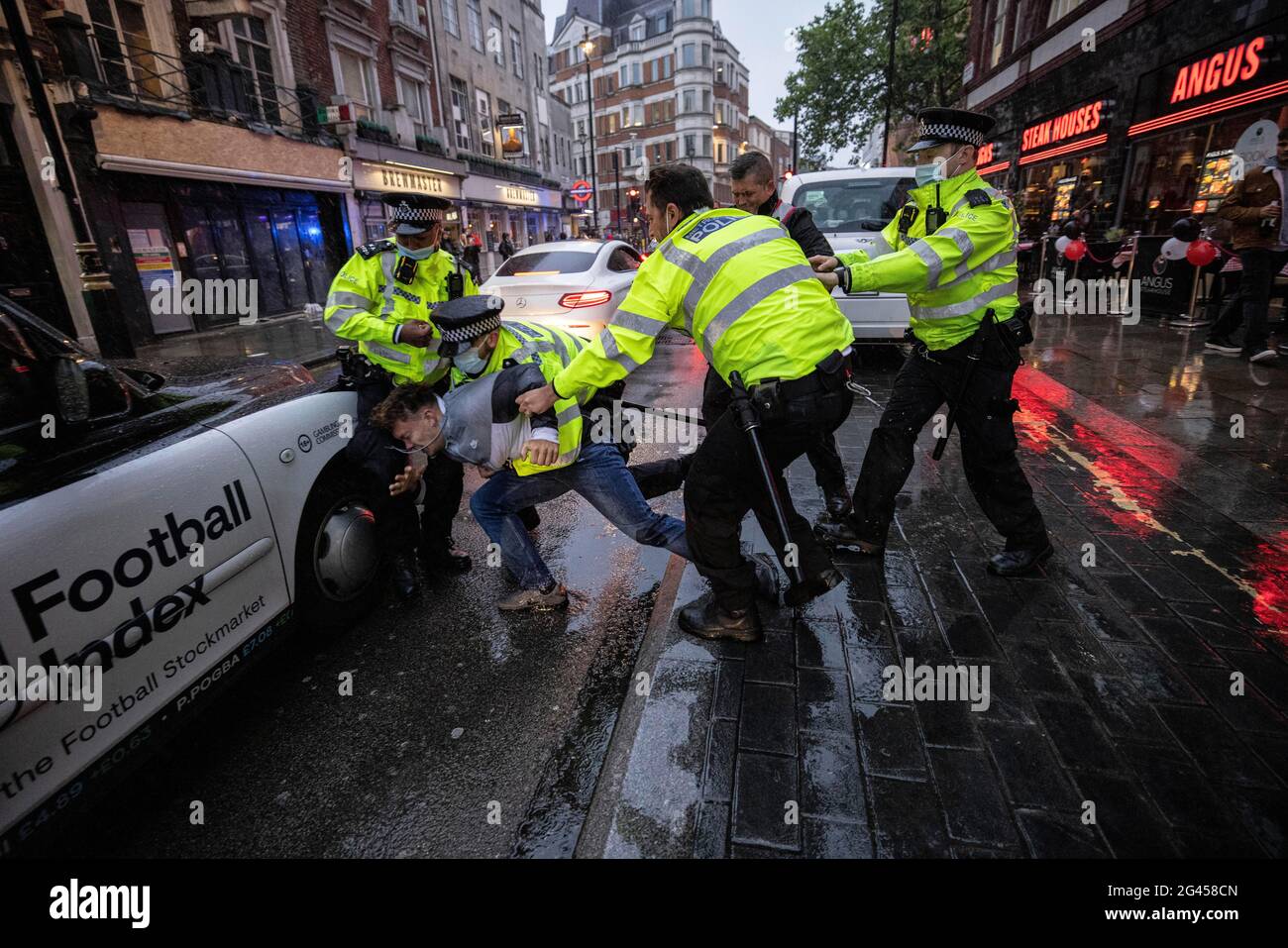 London, UK. 18th June 2021. Police make an arrest as English and Scottish fans clash in Leicester Square, Central London ahead of the EURO21 match against England. Credit: Jeff Gilbert/Alamy Live News Stock Photo