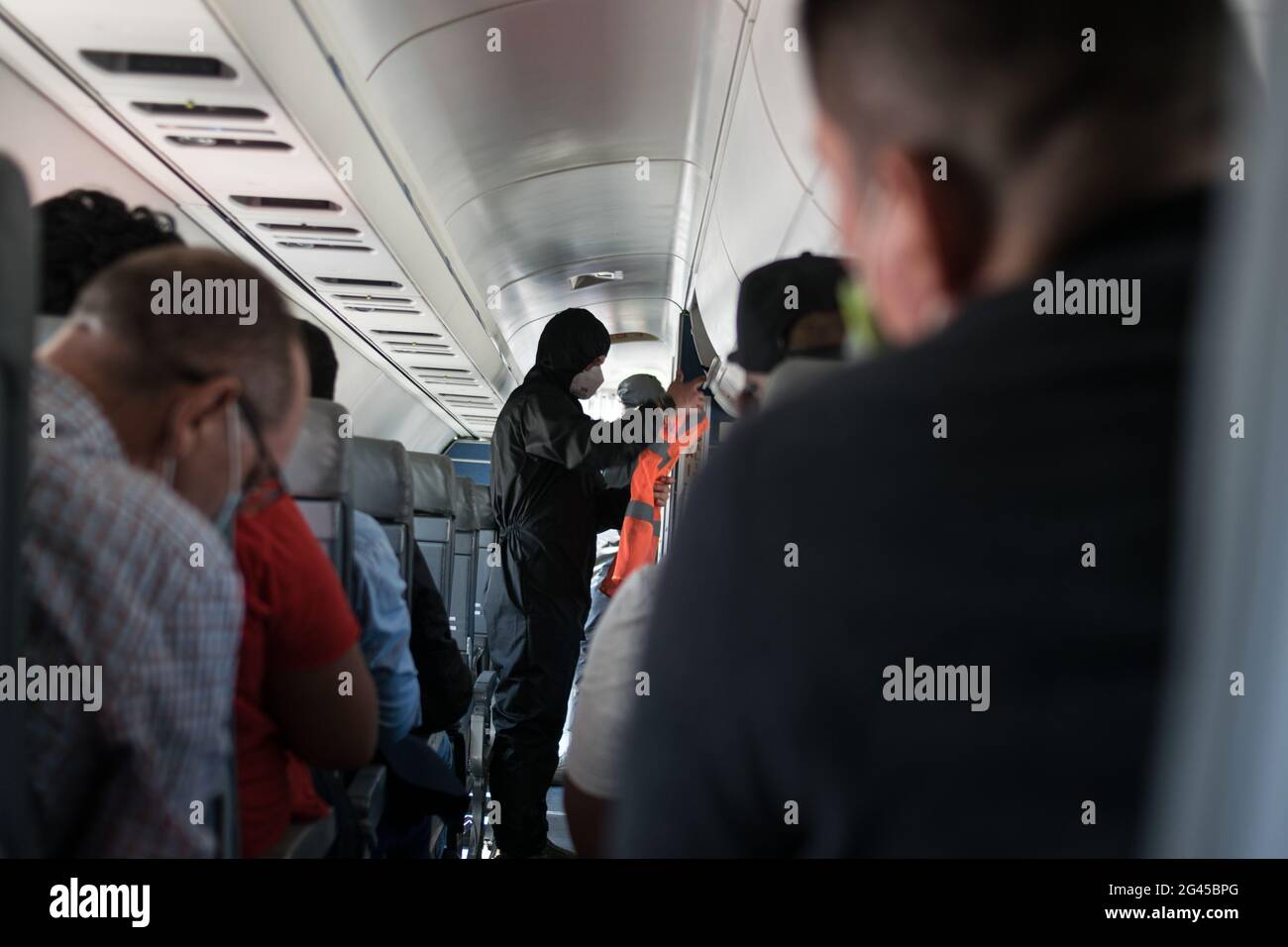 A flight attendant using a antifluid vest prepares safety instructions as the Colombian government sponsored free repatriation flights back to Colombia admist the novel Coronavirus (COVID-19) outbreak and the result of commercial flights grounded, in Miami, Florida, U.S, on August 7, 2020. Stock Photo