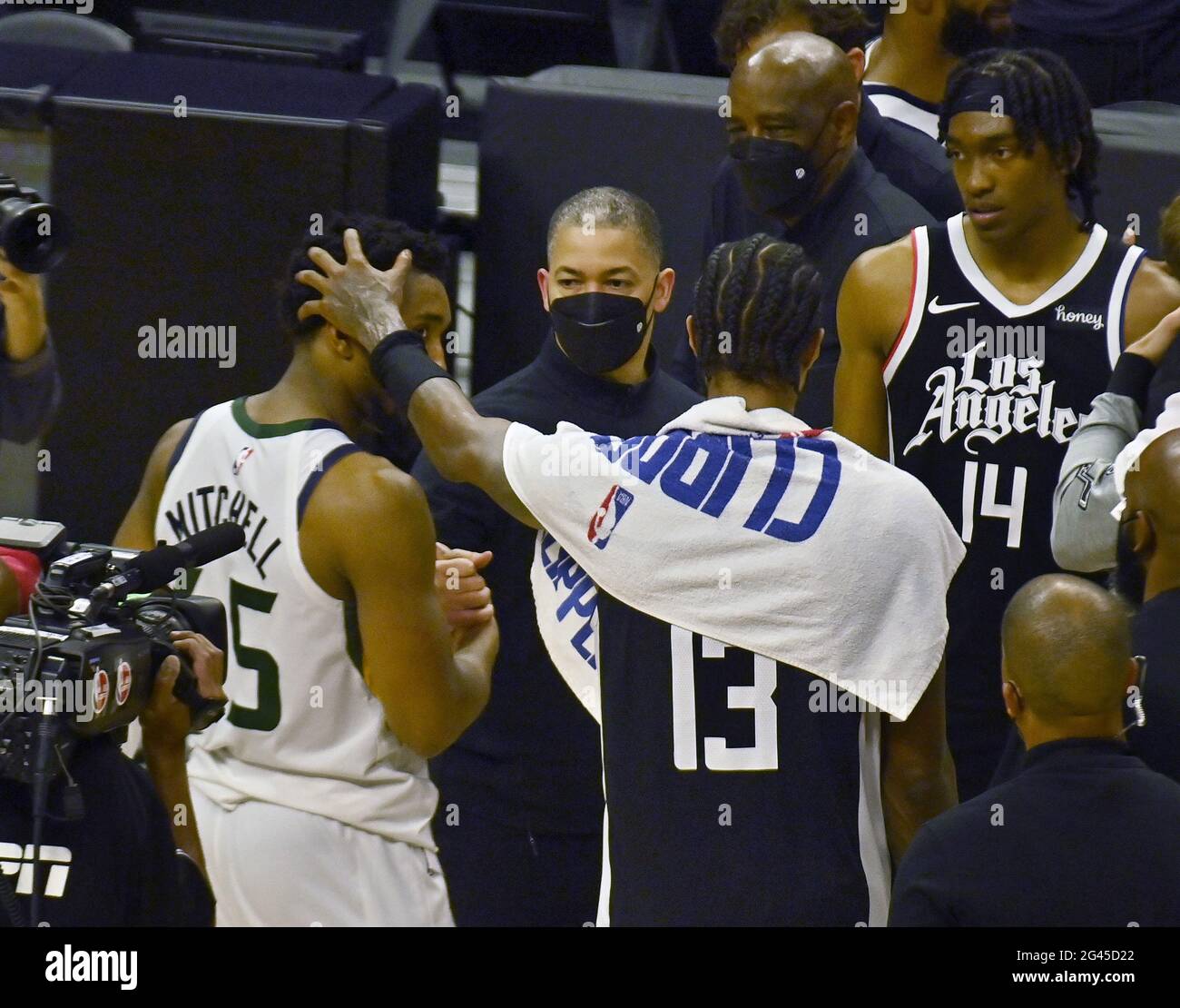 Los Angeles, USA. 19th June, 2021. Los Angeles Clippers guard Paul George (13) rubs Utah Jazz guard Donovan Mitchell's (45) head as Clippers coach Tyronn Lue (C) shakes his hand and guard Terance Mann (14) looks on at the end of Games 6 of their best-of-seven second-round playoff series at Staples Center in Los Angeles on Friday, June 18, 2021. The Clippers eliminated the top-seeded Jazz with a 131-119 win in front of Los Angeles' biggest NBA crowd since the pandemic shut down sports in March 2020. Photo by Jim Ruymen/UPI Credit: UPI/Alamy Live News Stock Photo