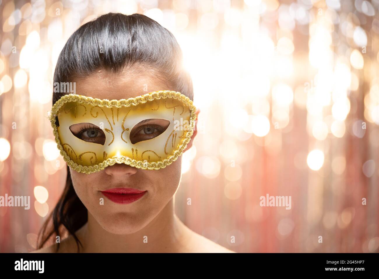 Caucasian woman wearing a carnival mask Stock Photo - Alamy