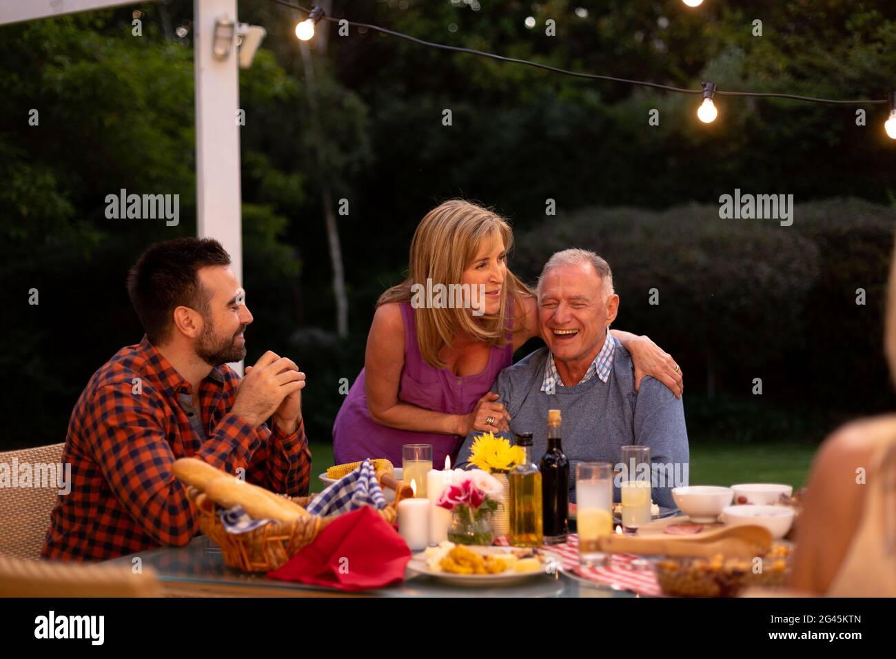 Happy Caucasian family eating together at table Stock Photo