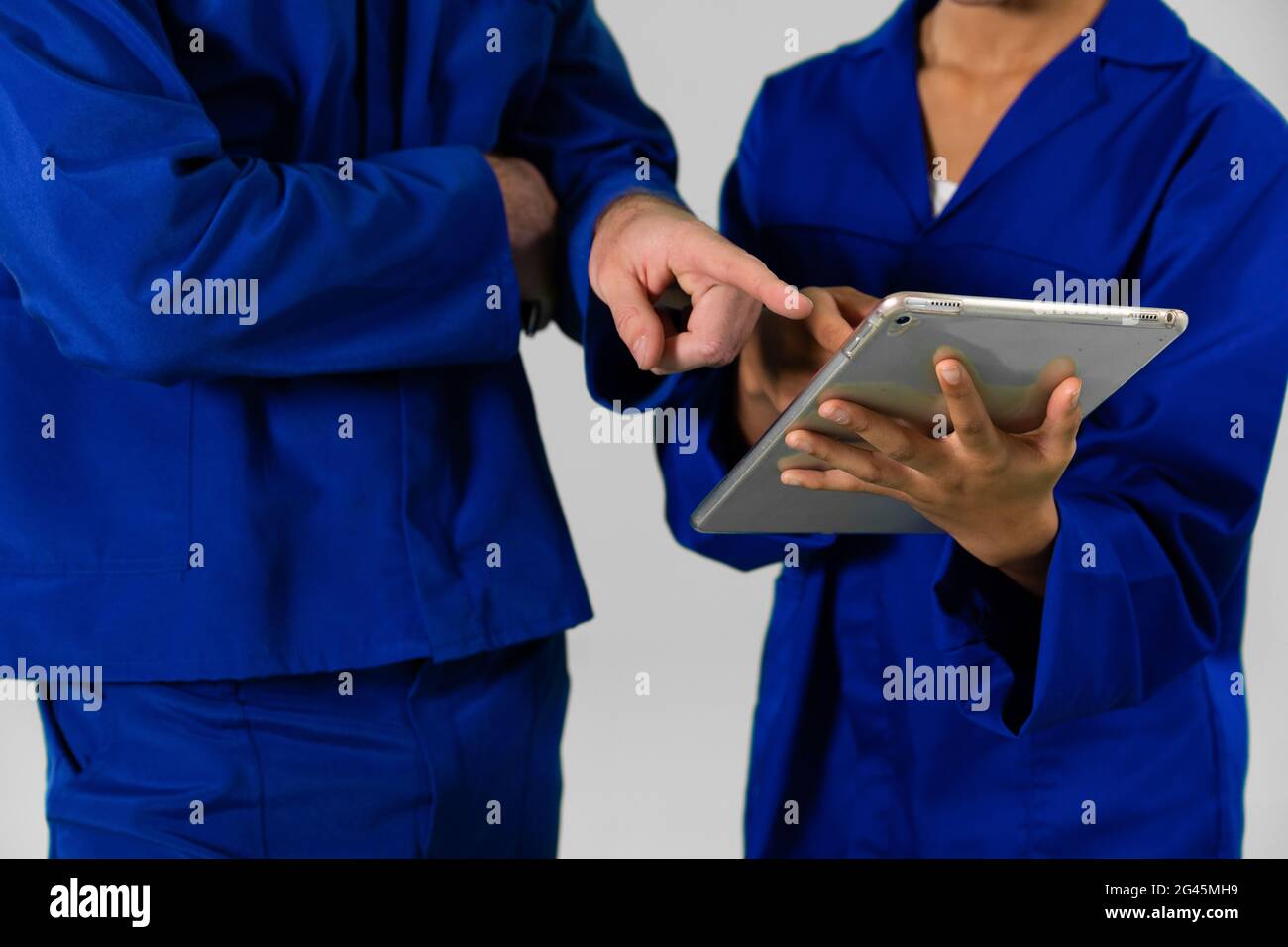 Engineers standing with digital tablet on white background Stock Photo