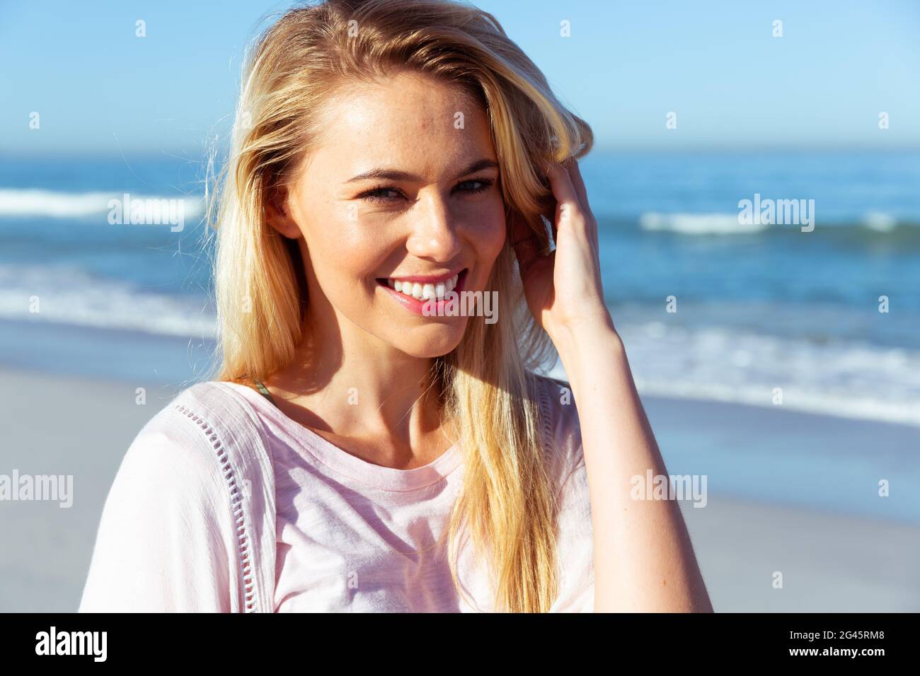 Portrait of woman smiling on the beach Stock Photo - Alamy