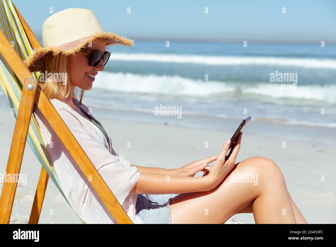 Caucasian woman using a digital tablet seaside Stock Photo - Alamy