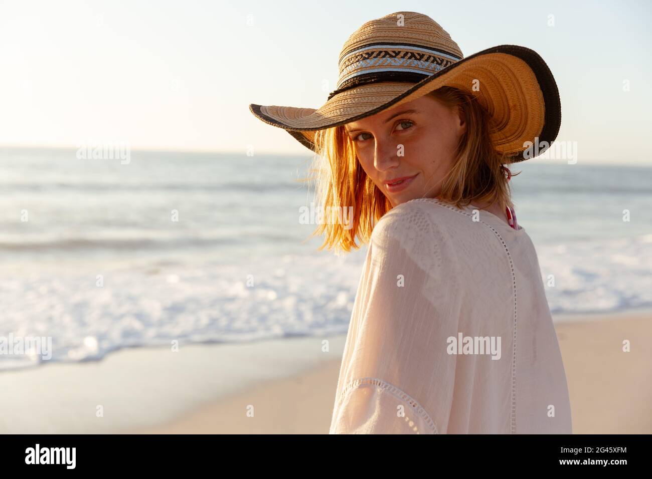 Portrait of woman wearing hat on the beach Stock Photo - Alamy