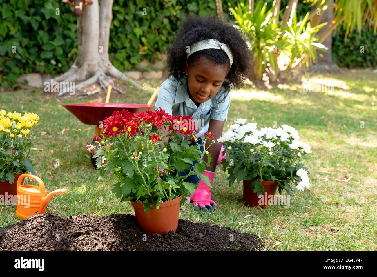 African American girl planting flowers Stock Photo - Alamy