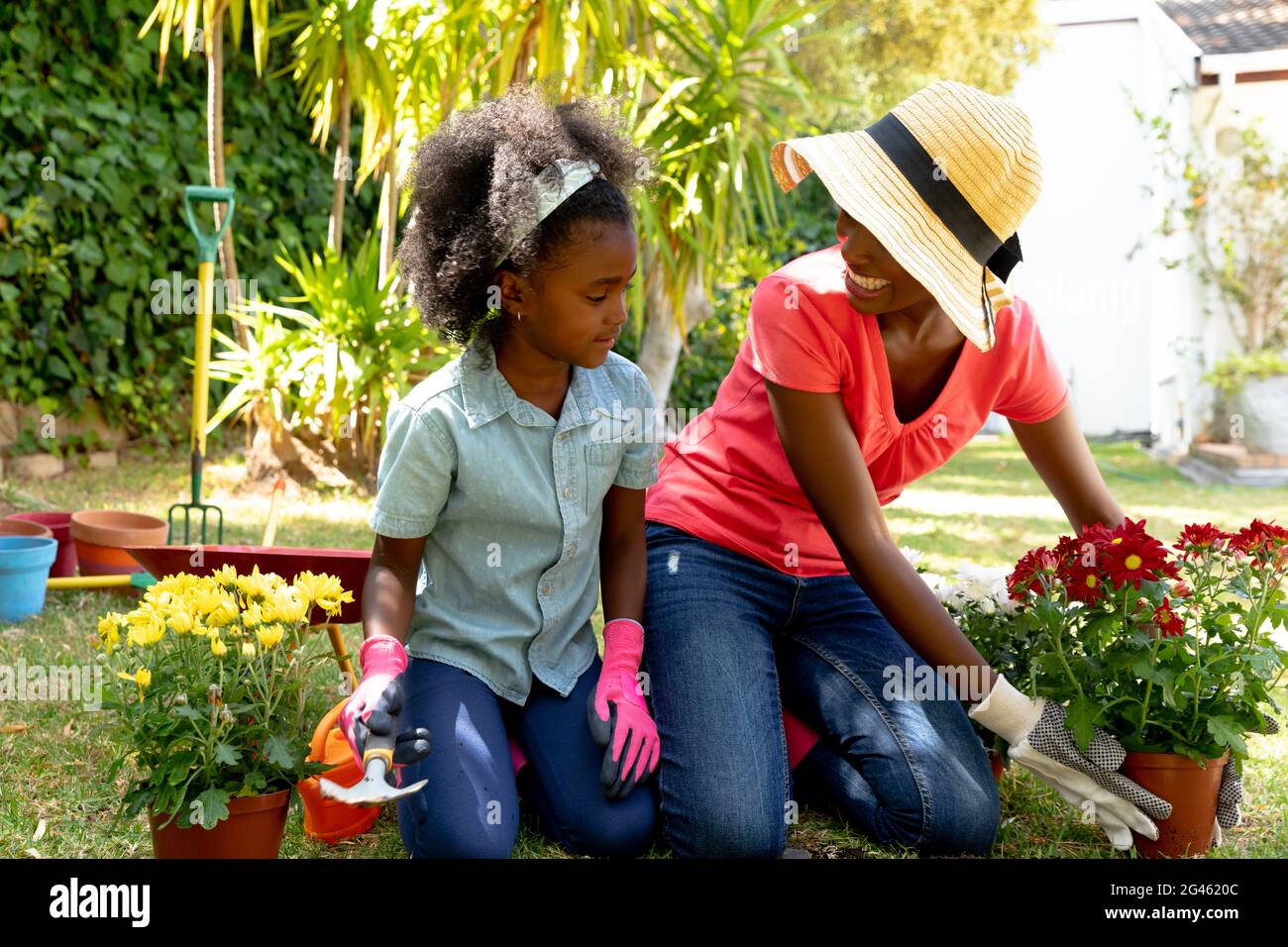 African American girl and her mother planting flowers Stock Photo - Alamy
