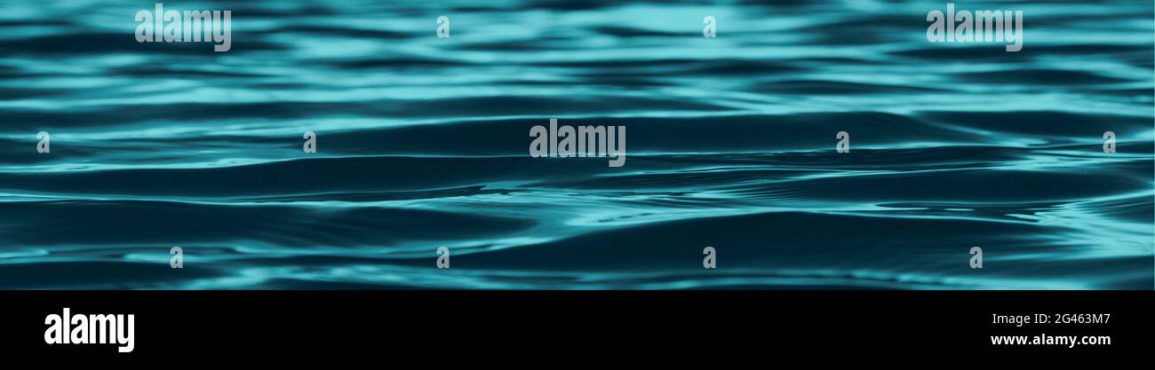 Dark blue green abstract background. Reflection of light on a smooth surface of water with small waves. Tidewater green background with copy space for Stock Photo