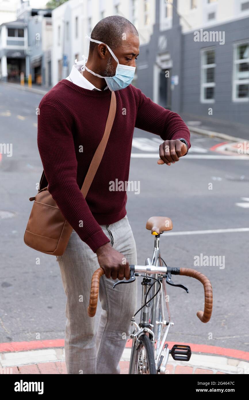 African American wearing covid19 coronavirus mask and watching his ...
