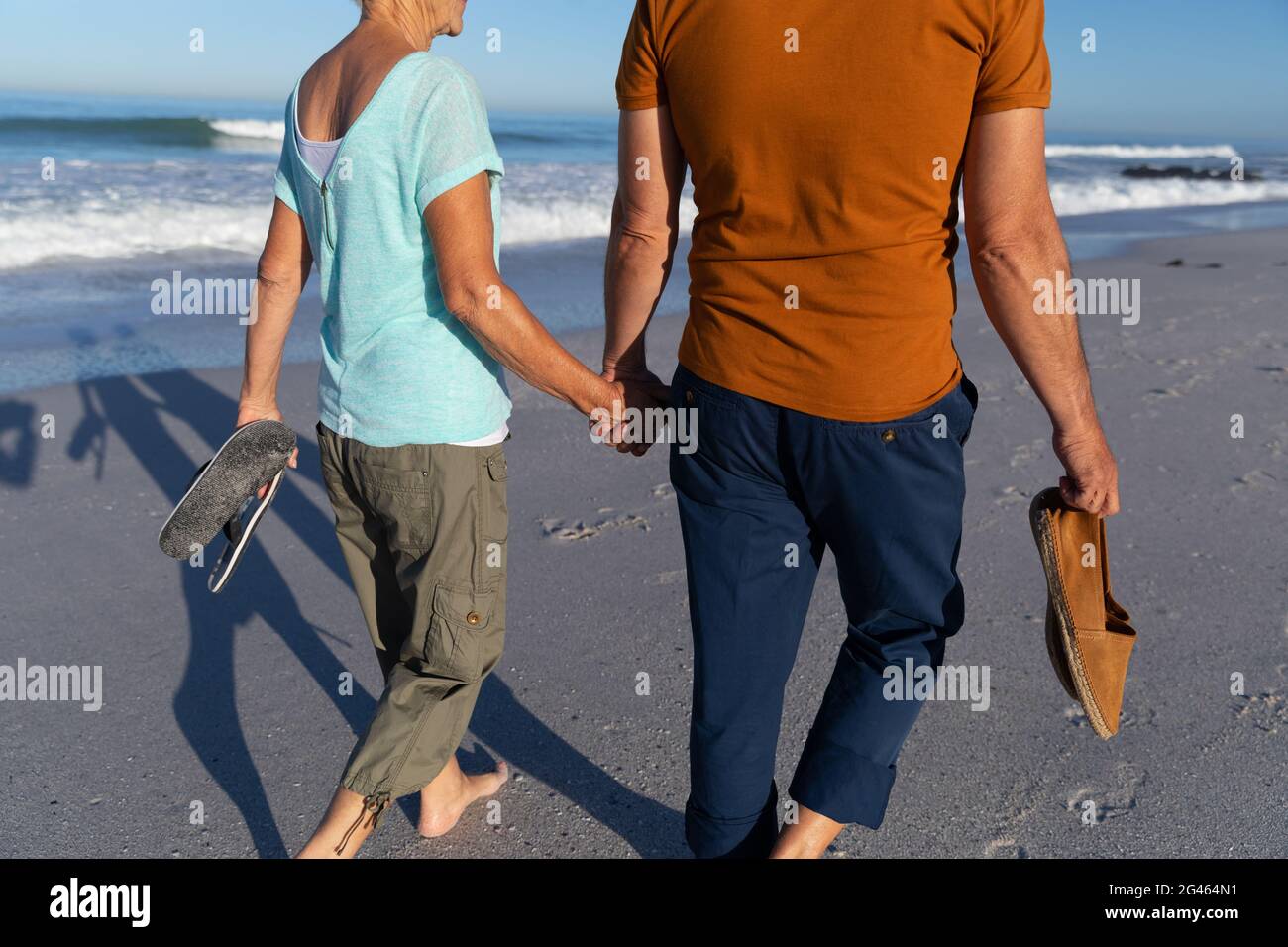 Senior Caucasian couple walking at the beach Stock Photo - Alamy