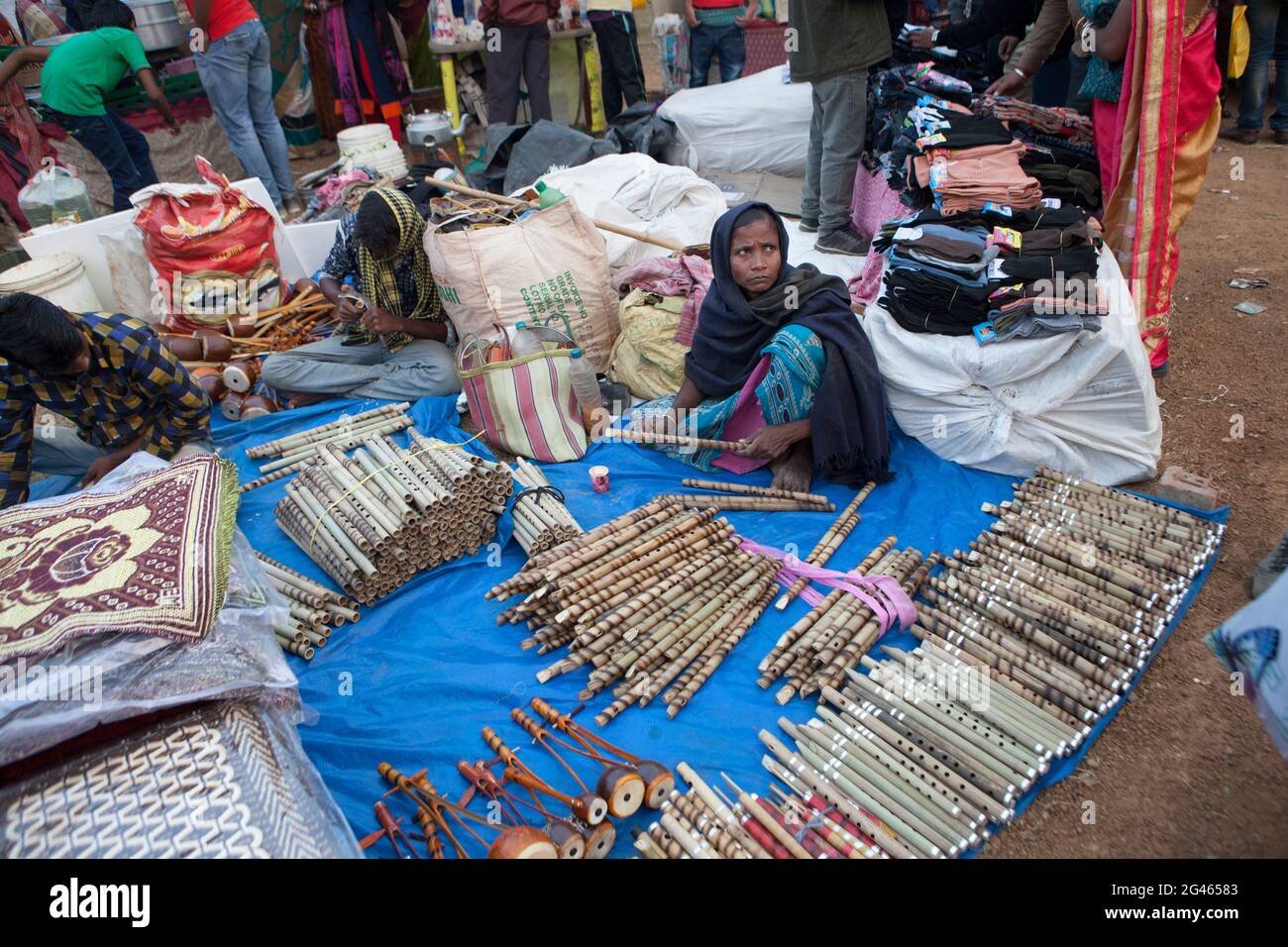A tribal lady selling traditional bamboo flutes in Poush Mela, a rural historical fair of about