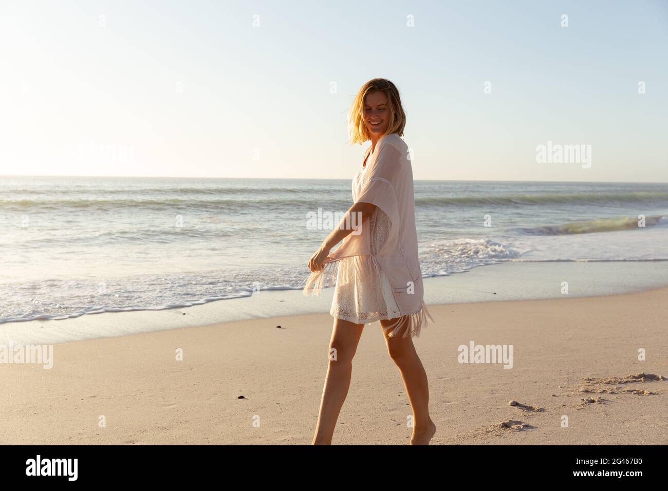 Beautiful woman walking on the beach Stock Photo - Alamy