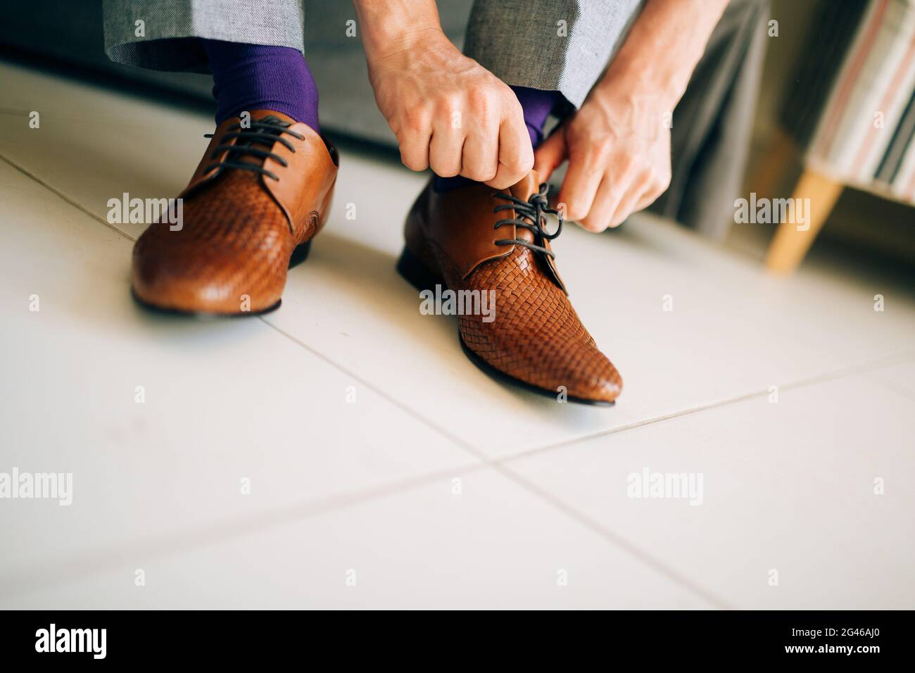 The man in gray slacks and a purple dress socks brown shoes with Stock Photo