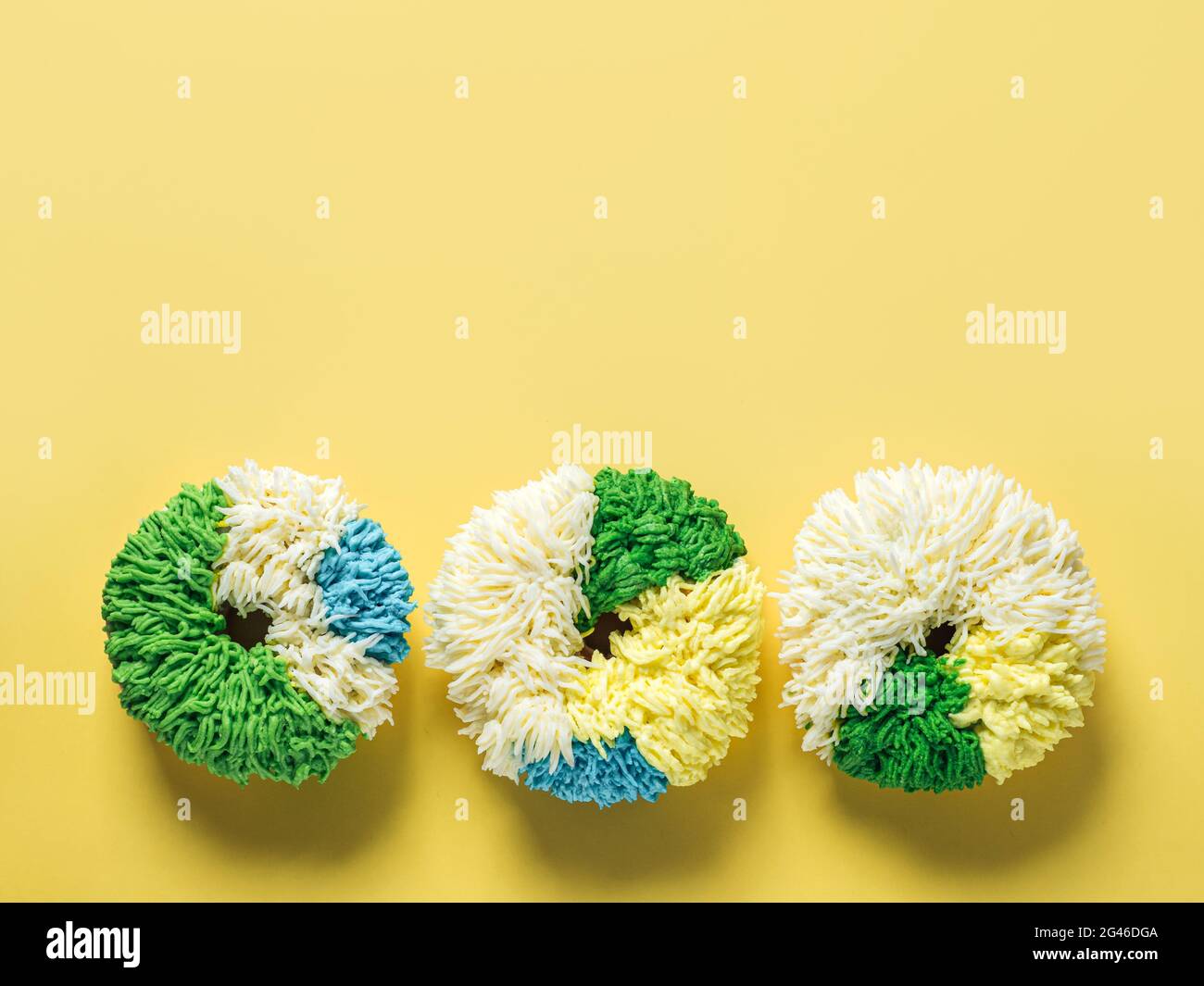 Shag donuts on yellow background, copy space Stock Photo