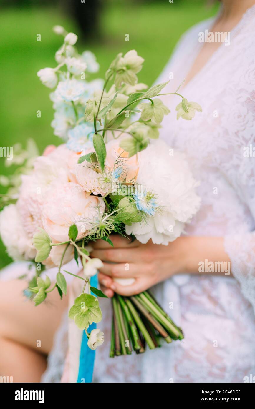 Wedding bouquet of peonies in the hands of the bride. Wedding in Stock ...