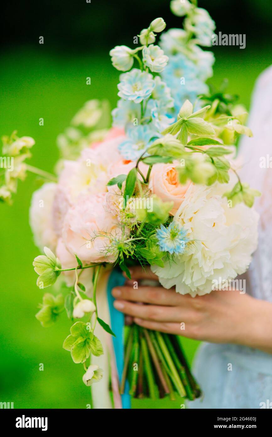 Wedding bouquet of peonies in the hands of the bride. Wedding in Stock ...