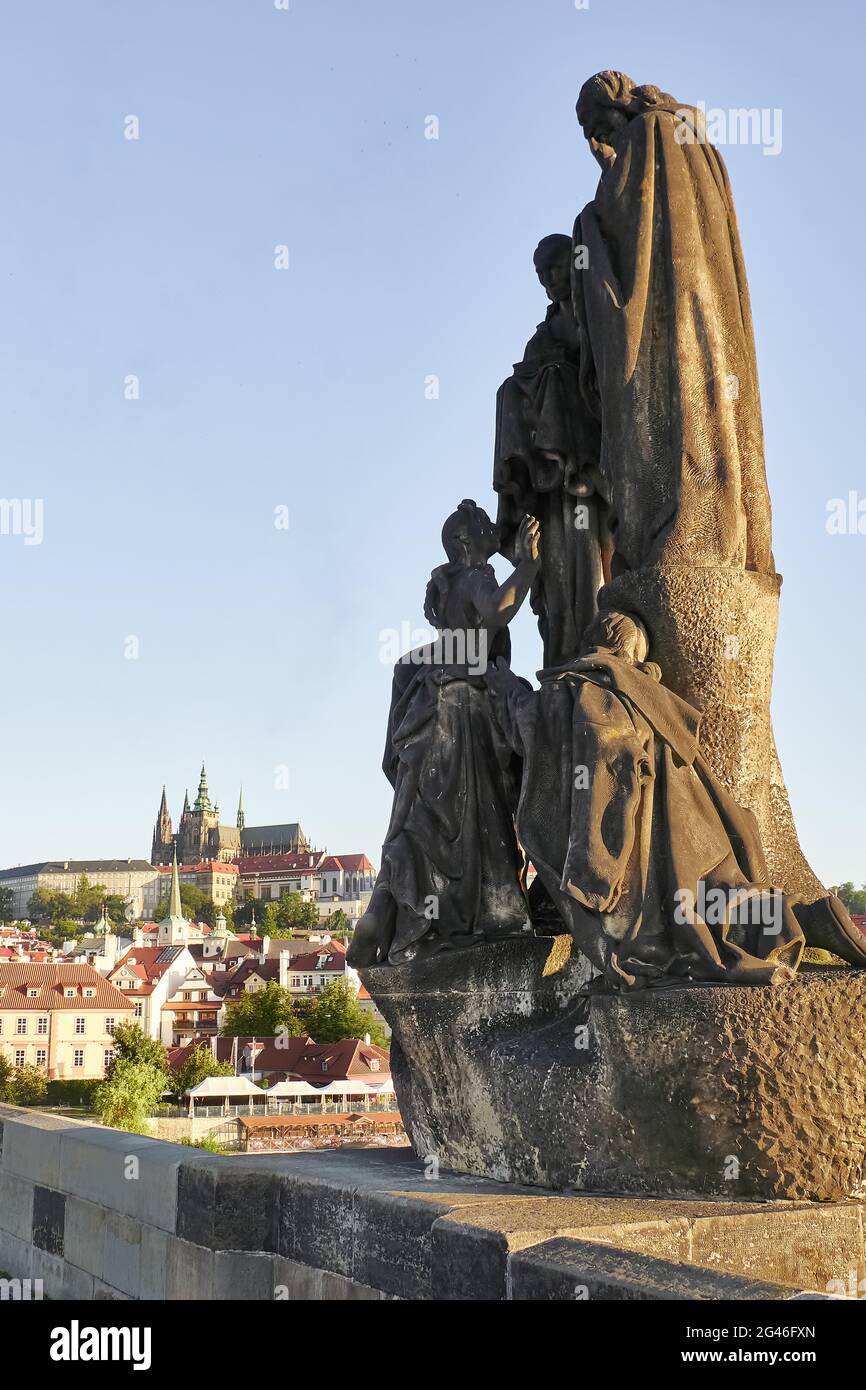 The statues of St. Cyril and St. Methodius on Charles Bridge with Prague Castle and St. Vitus Cathedral in the background, Prague, Czech Republic Stock Photo