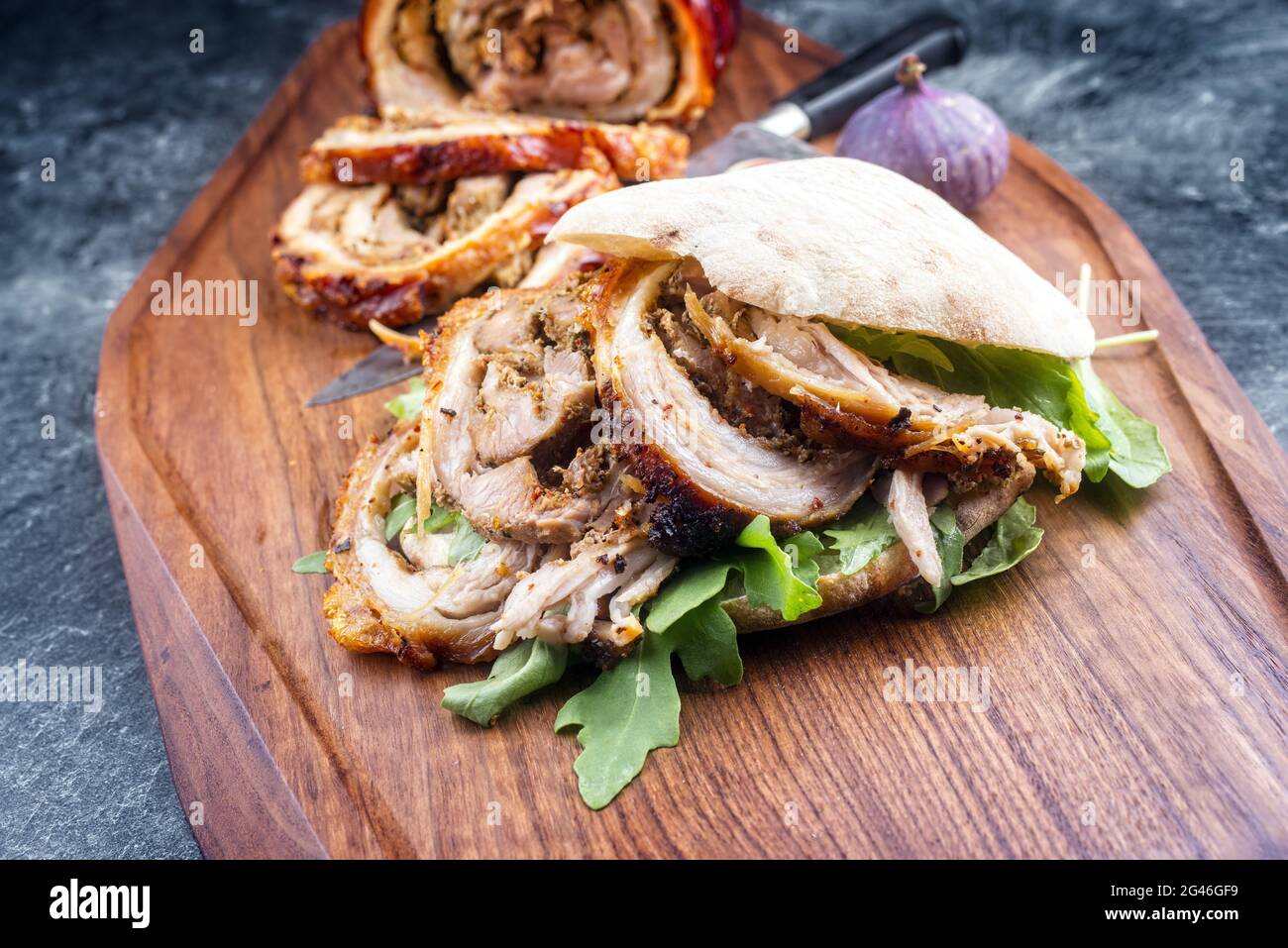Traditional Italian Porchetta arrotolata pork meat sandwich with pita
