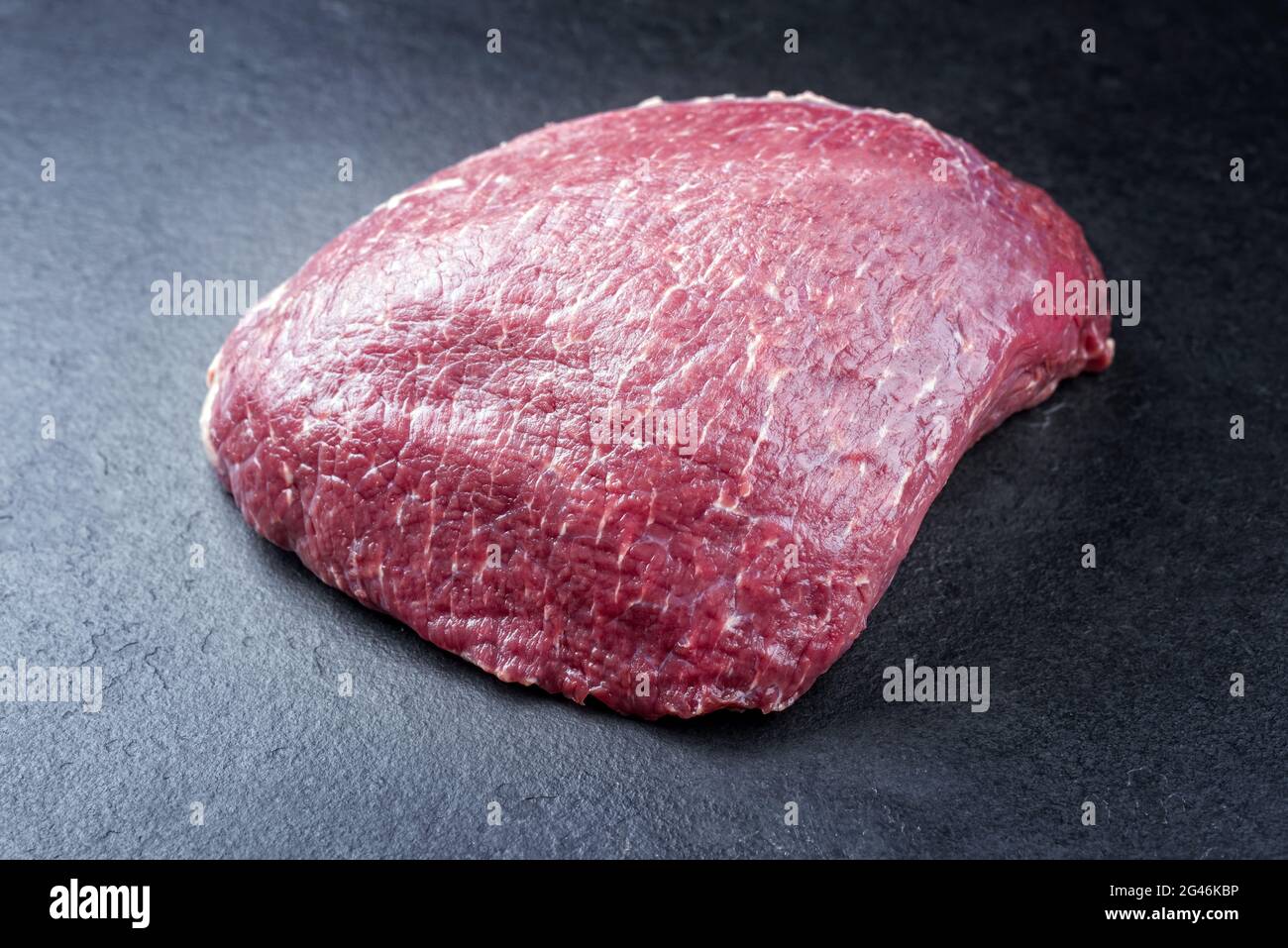 Raw dry aged wagyu beef rump steak piece as close-up on black ...