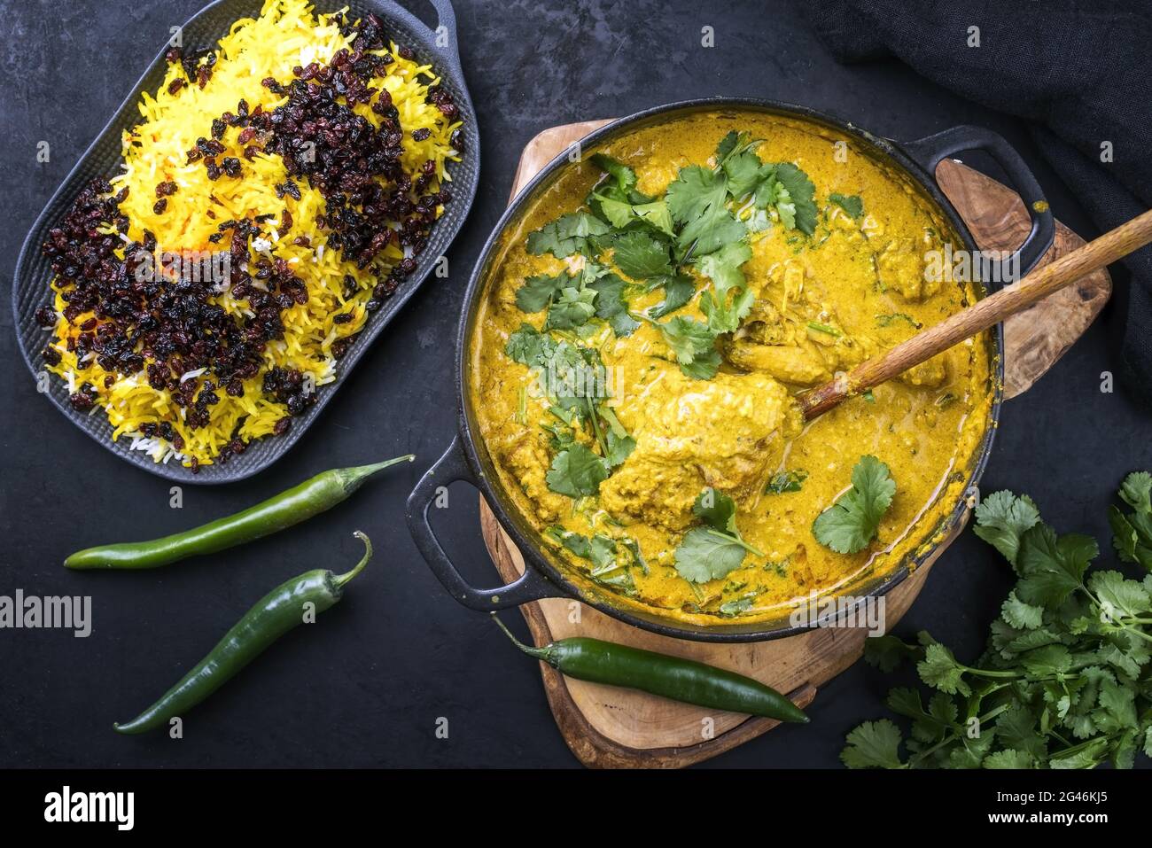 Traditional Indian chicken curry masala with saffron rice and berberis