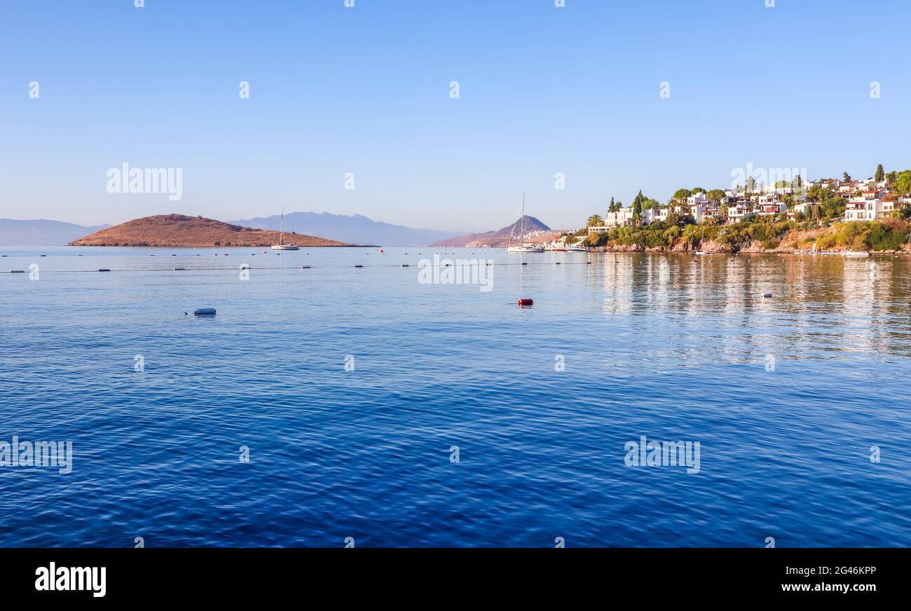 Aegean coast with marvelous blue water, rich nature, islands, mountains and small white houses Stock Photo