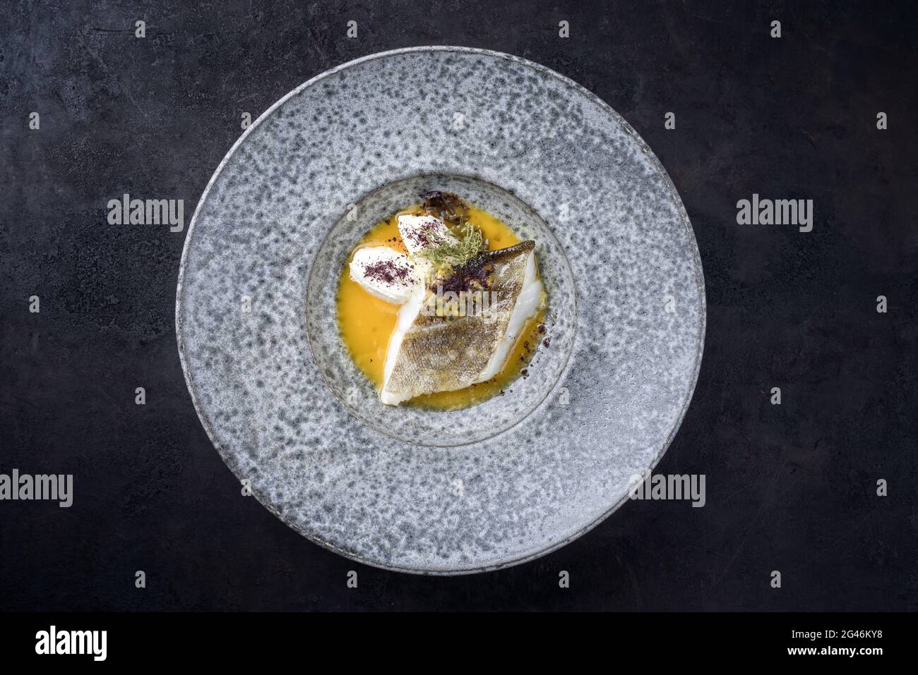 Modern style traditional sauteed skrei cod fish filet with skin with