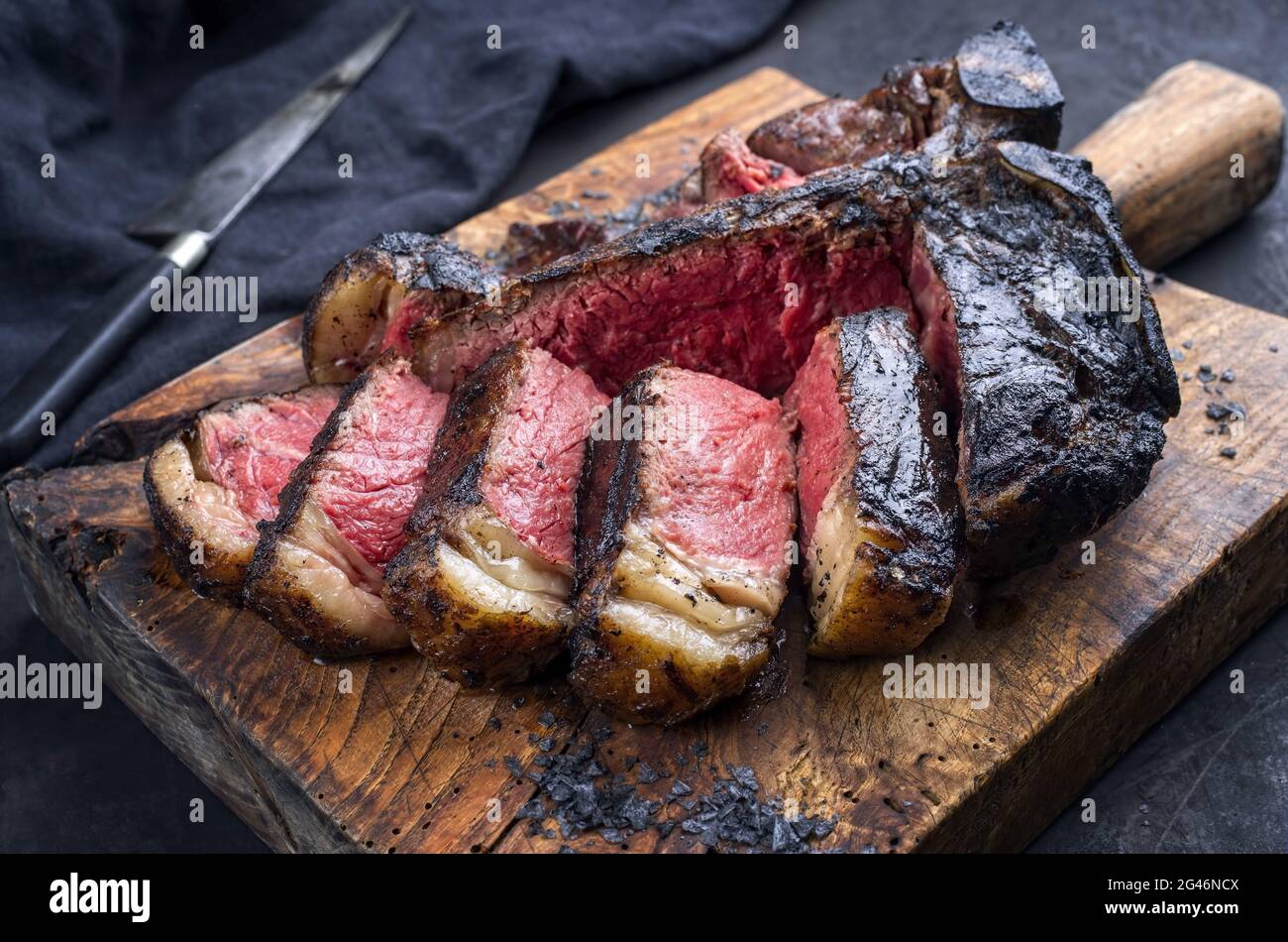 Traditional barbecue dry aged wagyu t-bone beef steak bistecca alla  Fiorentina sliced and served with black salt as close-up on Stock Photo -  Alamy