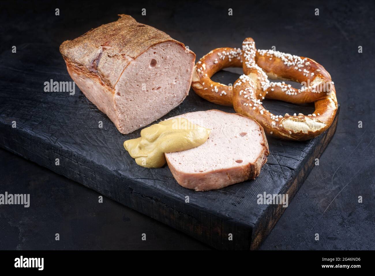 Traditional oven-fresh Bavarian leberkaese sliced and as piece served ...