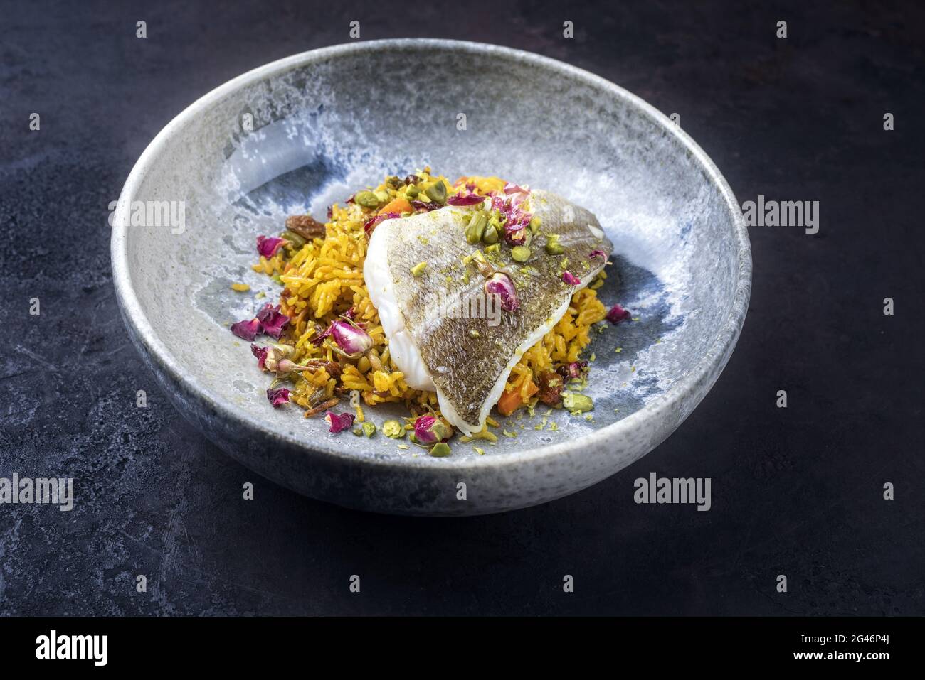 Modern style traditional sauteed skrei cod fish filet with skin in a