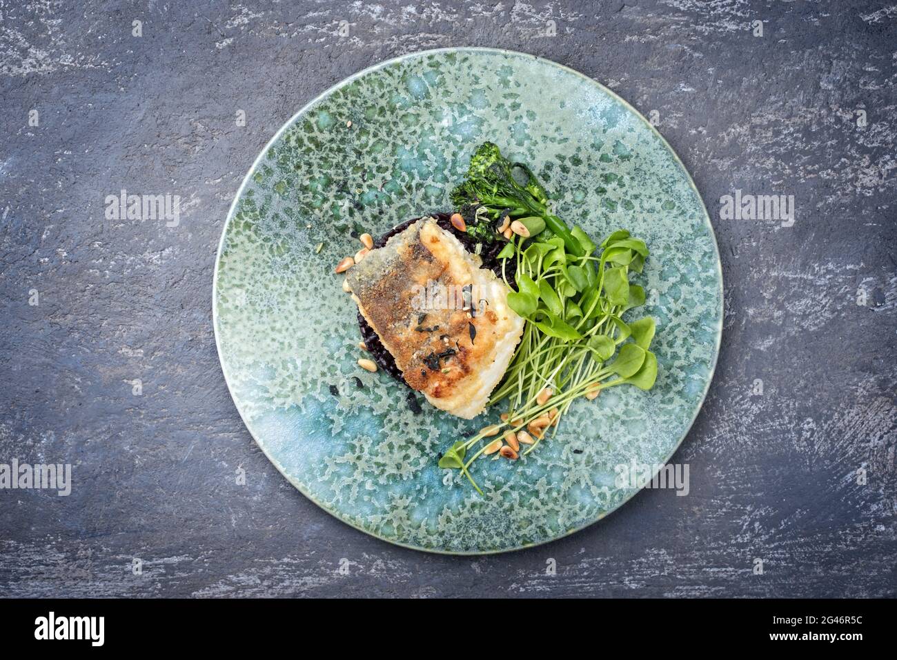 Modern style traditional panfried skrei cod fish filet in breadcrumbs