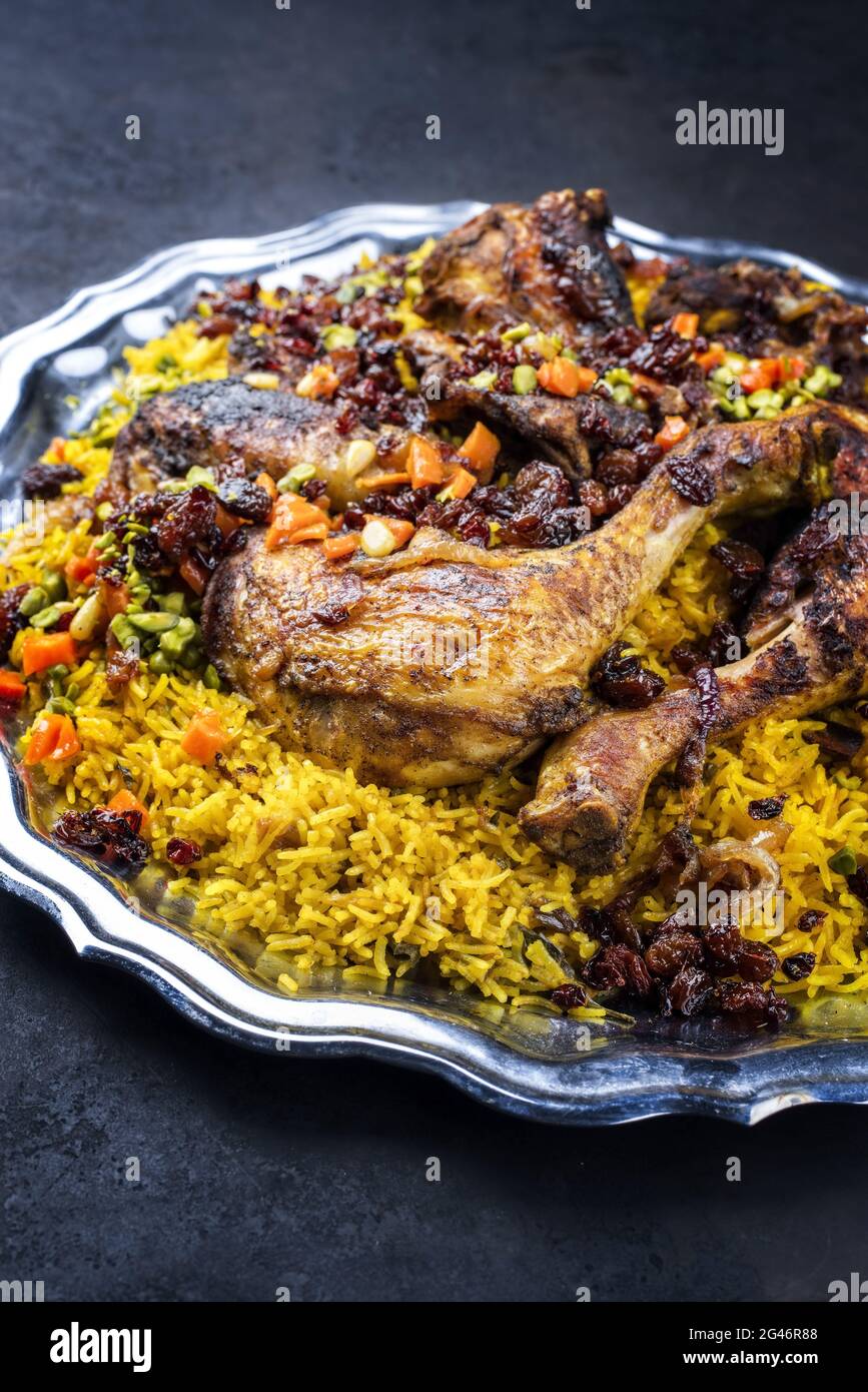 Traditional fried Arabic chicken majboos with chicken leg and jeweled