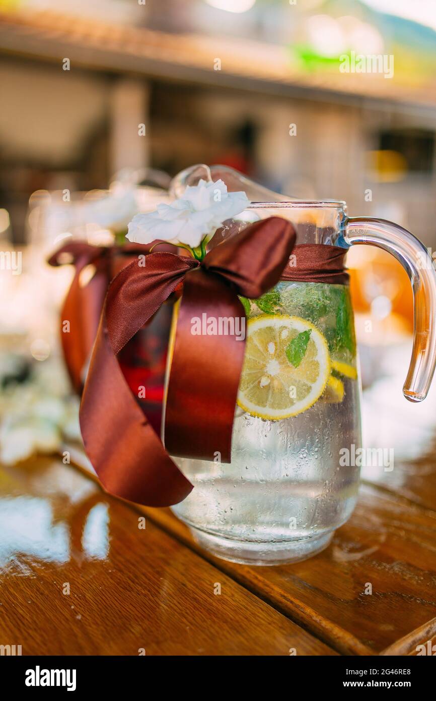 Decanters with fruit lemonade on the table at the wedding Stock Photo