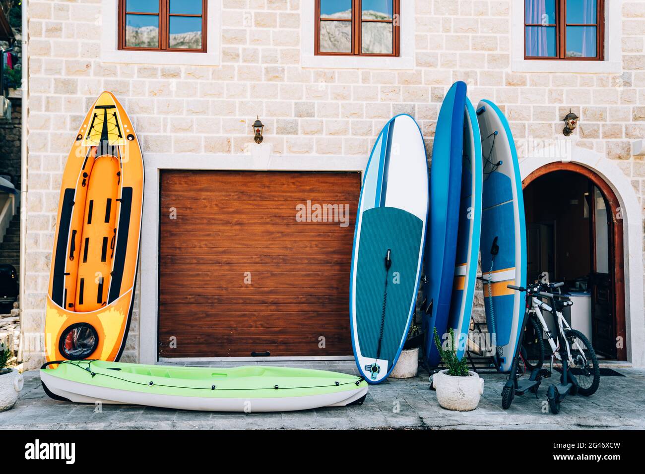 Sports travel equipment rental store - rubber boats, inflatable canoes and kayaks, gliding boards, bicycles and electric scooter Stock Photo