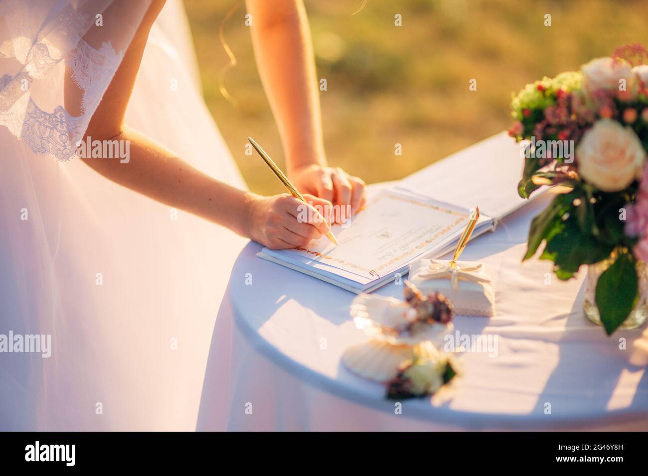 Newlyweds put their signatures in the act of registering a marriage Stock Photo