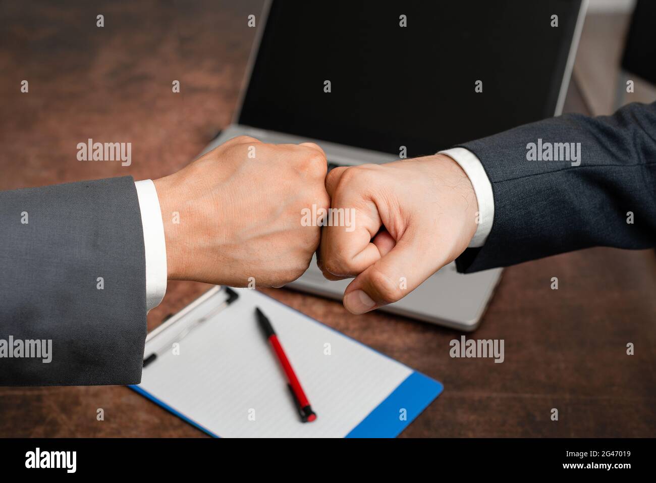 Corporate Businessmen Handshake Indoors.Two People Professionally Well Dressed Gesturing Togetherness.Working Colleague Partners Stock Photo