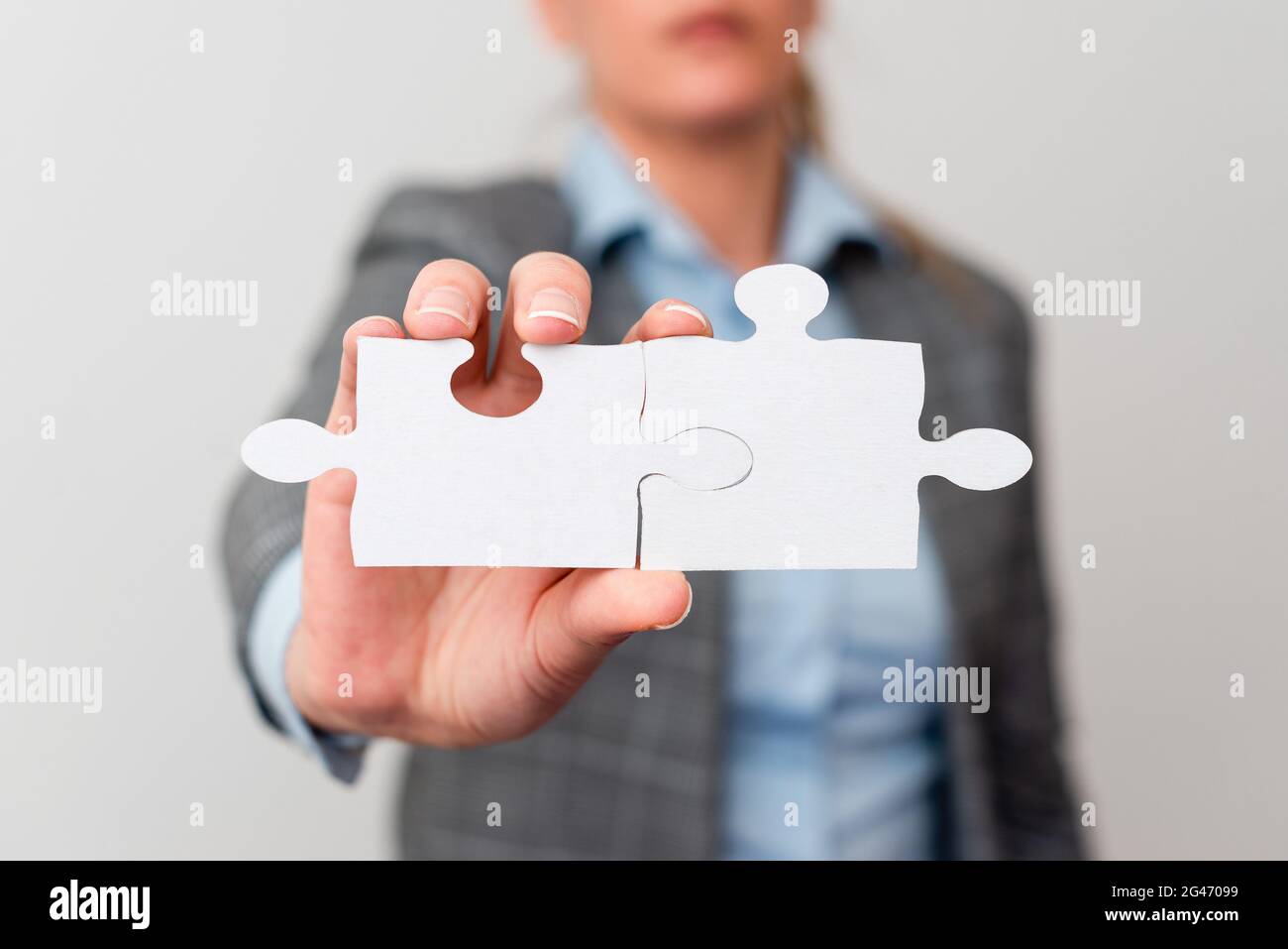 Welldressed Business Woman Holding Two Pieces Of Jigsaw Puzzle, Professional Adult Women Resolving Missing Ideas, Strategy For N Stock Photo