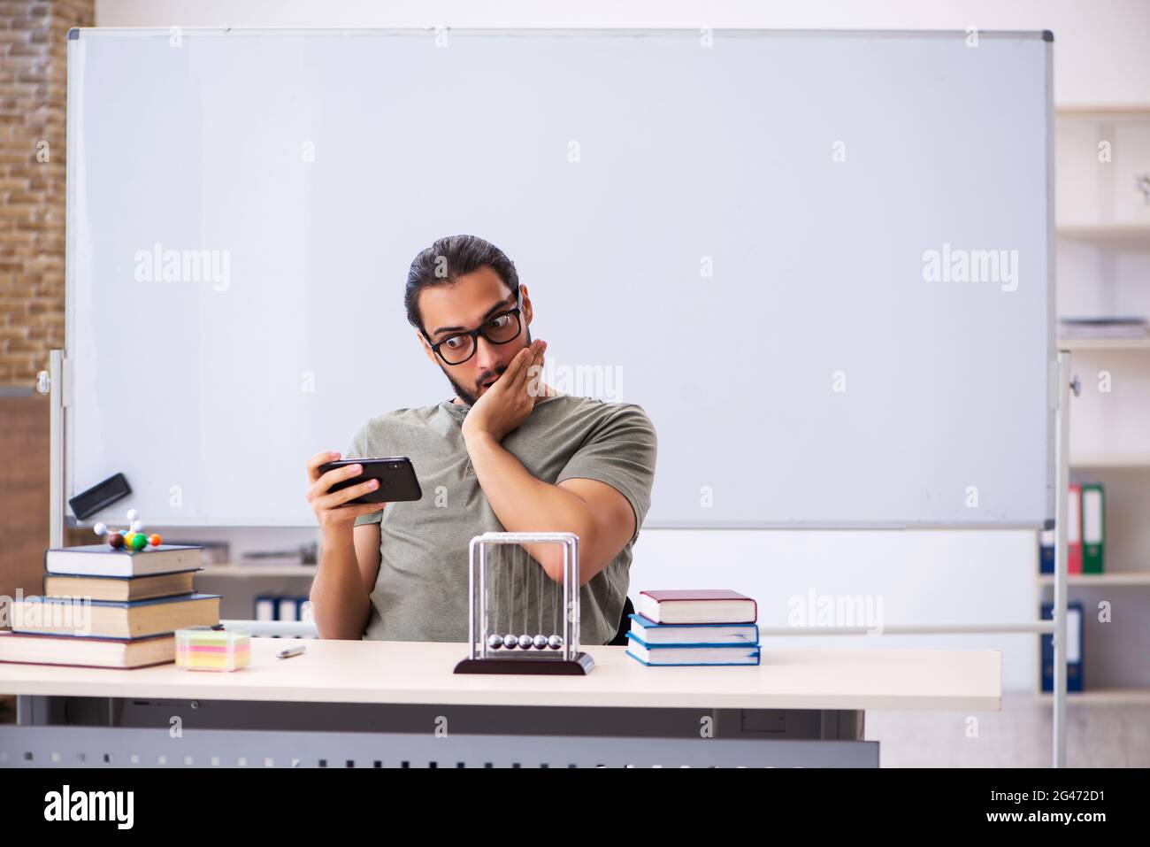 Young student preparing for exams in the classroom Stock Photo - Alamy