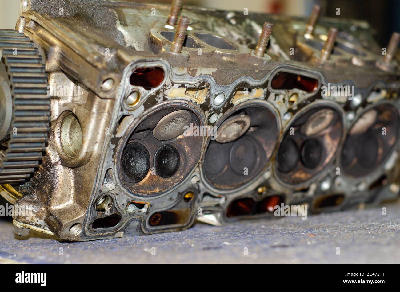 Closeup shot of disassemble engine head combustion chamber with dirty valves Stock Photo
