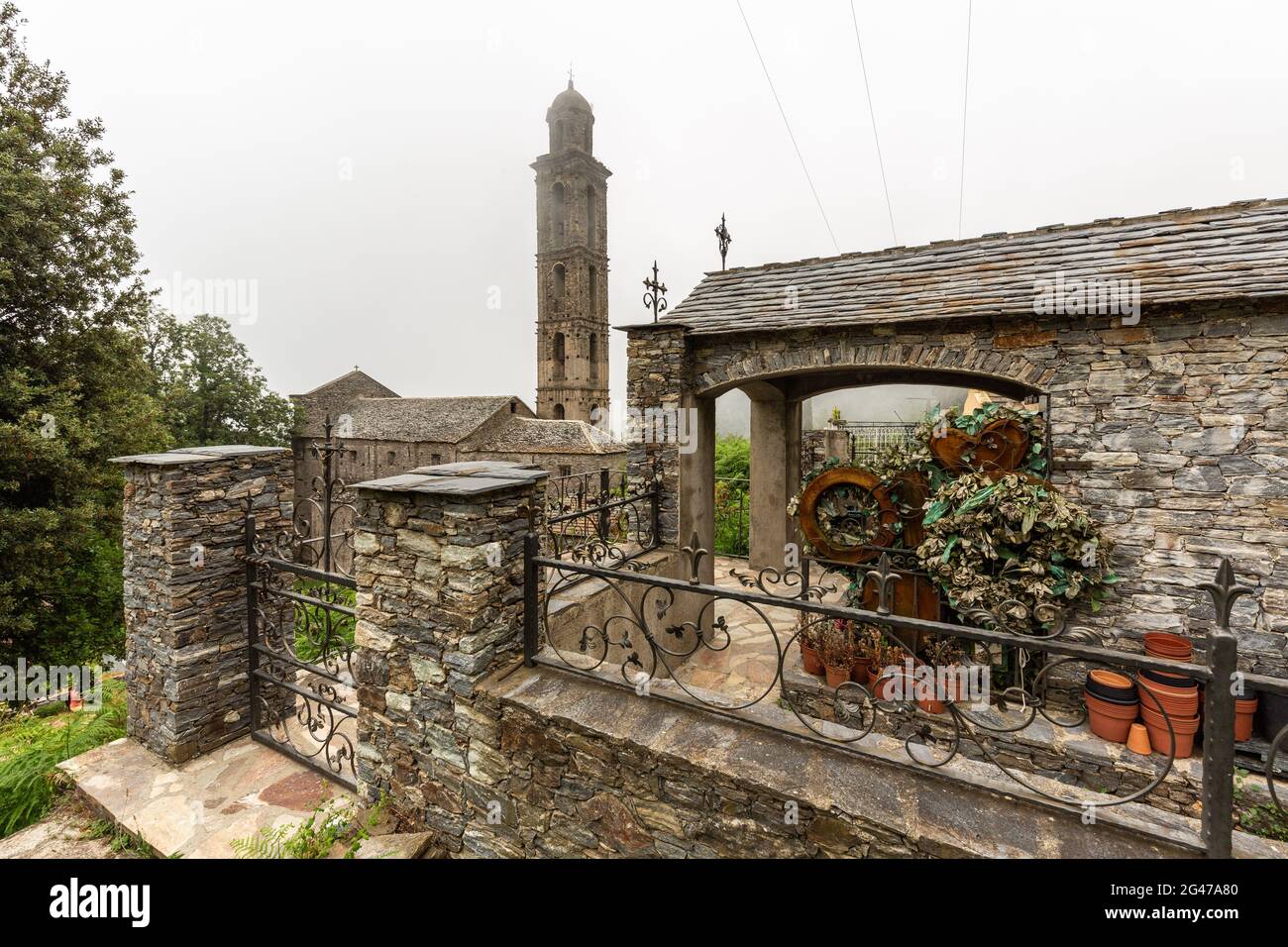 Bell tower of San-Giovanni-di-Moriani. Entrance of a house with its courtyard. Corsica, France Stock Photo