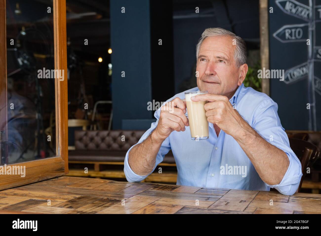 Senior thoughtful man holding cold coffee Stock Photo