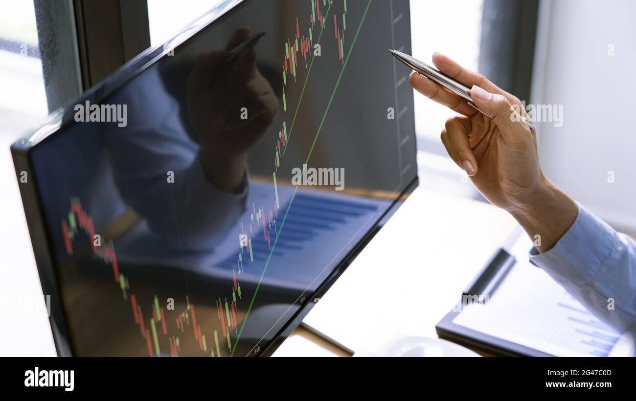 A monitor displaying the dynamic of real estate stock chart in the