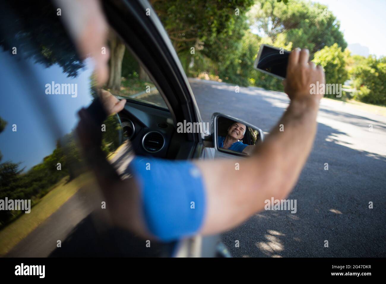 Senior man taking selfie while driving car Stock Photo - Alamy