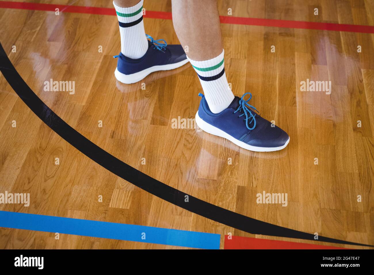 Basketball player standing in the court Stock Photo - Alamy
