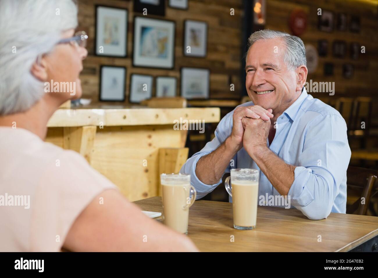 Senior couple interacting while having coffee Stock Photo